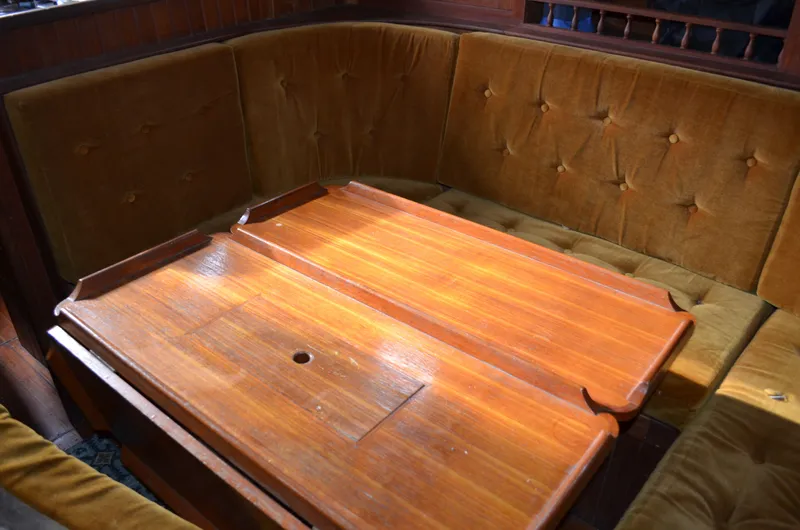 Slide: The Image of 1982 Young Sun Cutter interior with wooden table and cushioned seating. - 8