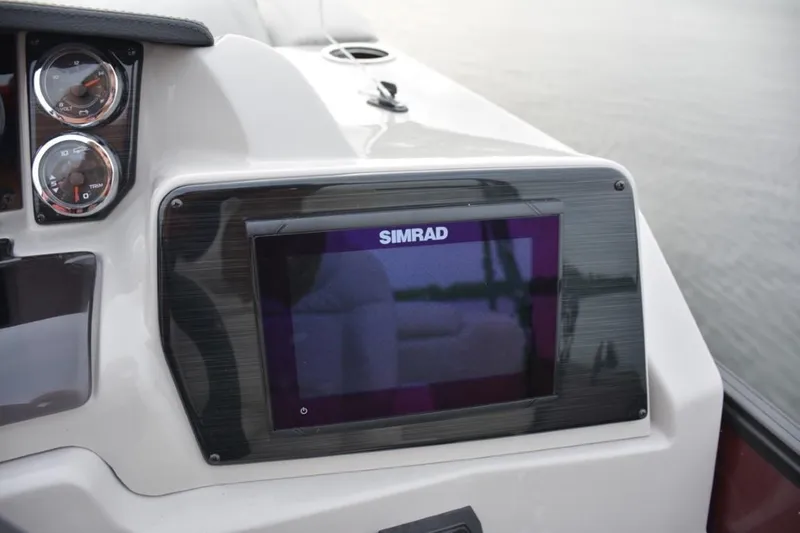 Slide: The Image of 2023 Starcraft SLS 3 boat dashboard with Simrad display and gauges. - 9