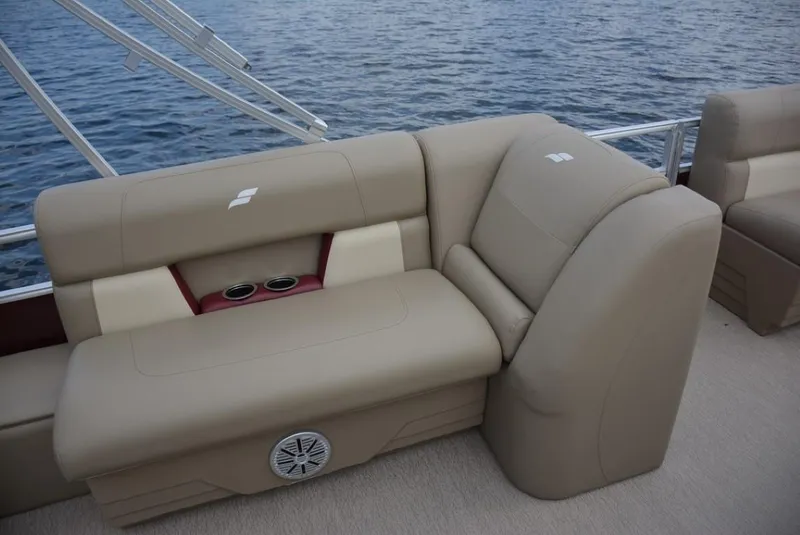 Slide: The Image of 2023 Starcraft LX 22 boat interior with beige seating and cup holders. - 19