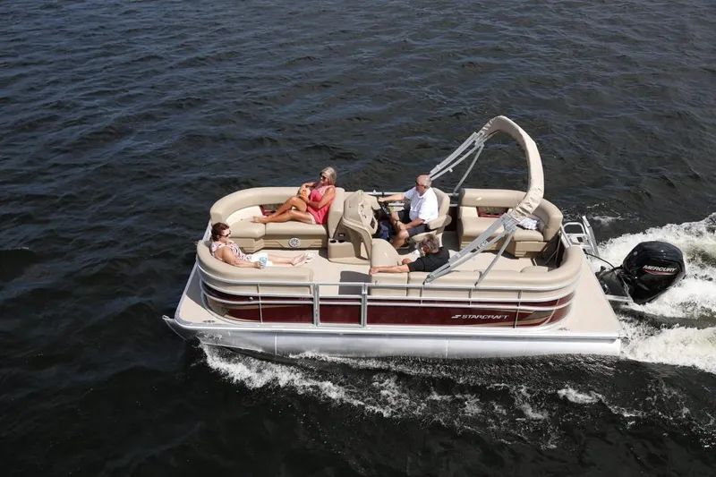 Slide: The Image of 2023 Starcraft LX 22 pontoon boat cruising on the water with passengers. - 3