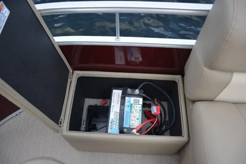 Slide: The Image of 2023 Starcraft LX 20 boat battery compartment with open lid. - 18