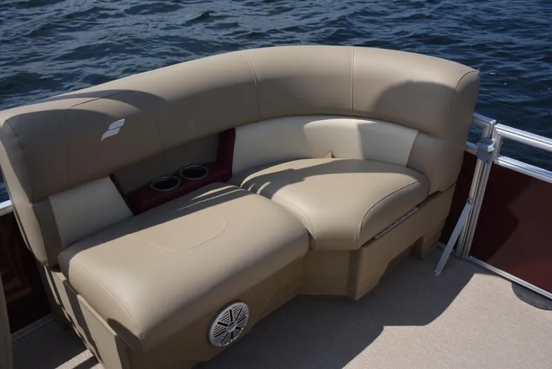 Slide: The Image of 2023 Starcraft LX 20 pontoon boat with tan seating and cup holders. - 8