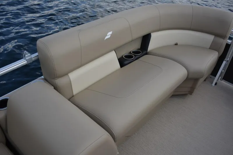Slide: The Image of 2023 Starcraft LX 16 boat with beige seating and cup holders on water. - 11
