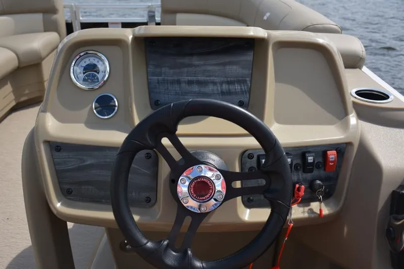 Slide: The Image of 2023 Starcraft LX 16 boat dashboard with steering wheel and gauges. - 5