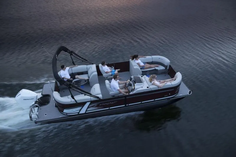 Slide: The Image of 2023 Starcraft SLS 5 pontoon boat cruising on a lake with passengers. - 9