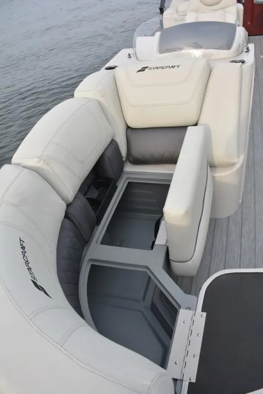 Slide: The Image of 2023 Starcraft SLS 1 boat with white cushioned seating and storage compartment. - 12