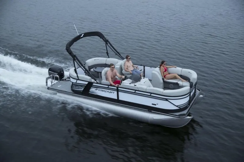 Slide: The Image of 2023 Starcraft SLS 1 pontoon boat cruising on water with passengers. - 6