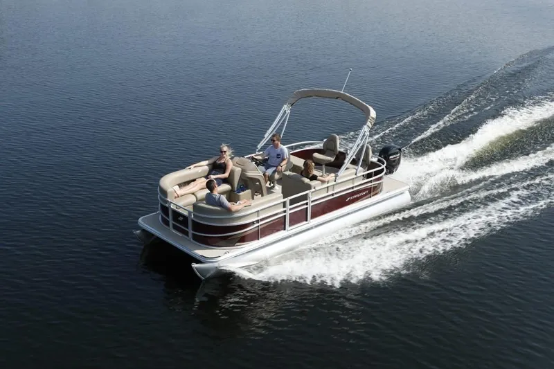 Slide: The Image of 2023 Starcraft EX 20 pontoon boat cruising on a lake. - 10