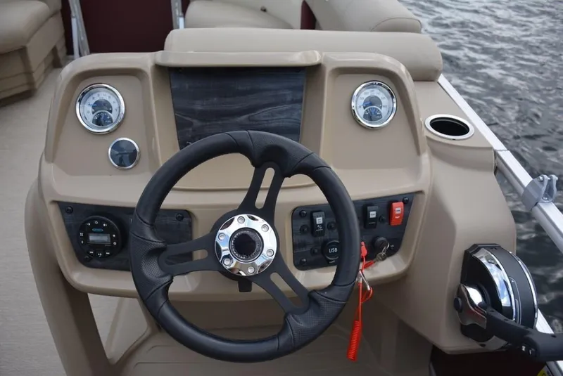 Slide: The Image of 2023 Starcraft EX 20 boat dashboard with steering wheel and control panel. - 16
