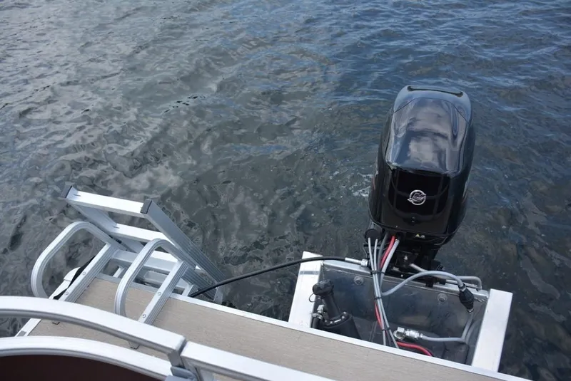 Slide: The Image of 2023 Starcraft EX 20 pontoon boat with outboard motor on water. - 25