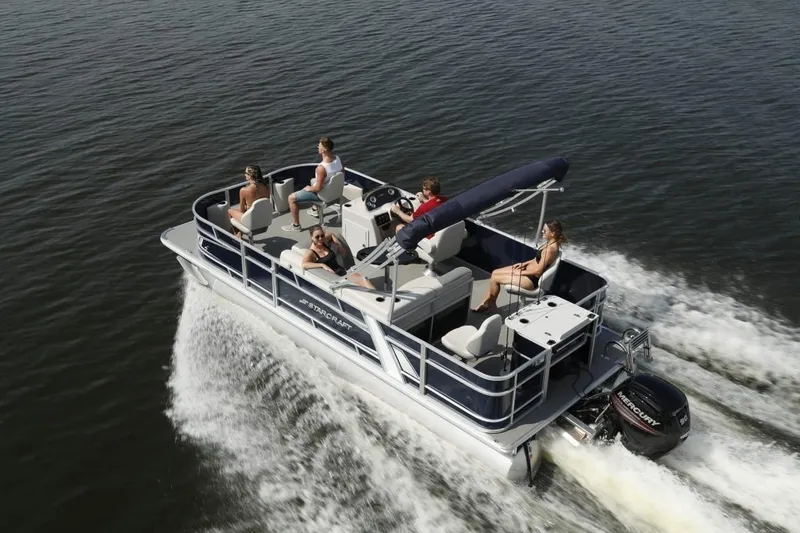 Slide: The Image of 2023 Starcraft EX 18 pontoon boat cruising with passengers on a lake. - 4