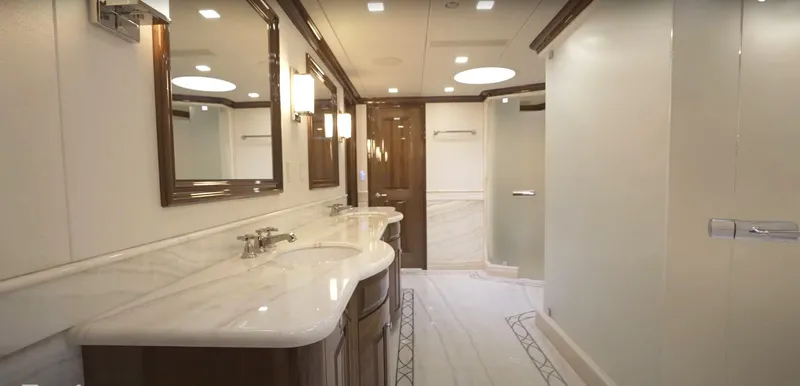 Slide: The Image of Luxurious Christensen 2020 yacht bathroom with double sinks, marble countertops, and modern lighting. - 10