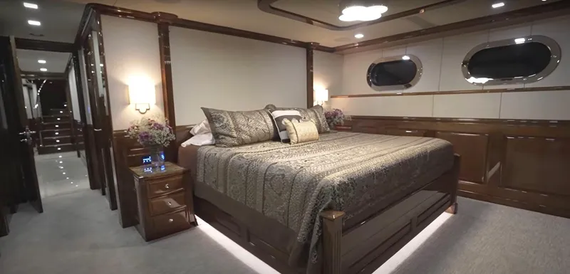 Slide: The Image of Luxurious bedroom in Christensen Model Year 2020 yacht, featuring elegant decor and ambient lighting. - 11