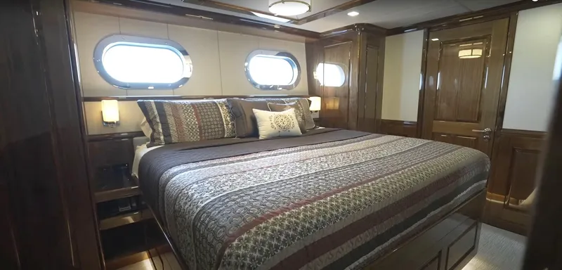 Slide: The Image of Luxurious bedroom in Christensen 2020 yacht with large bed and porthole windows. - 20
