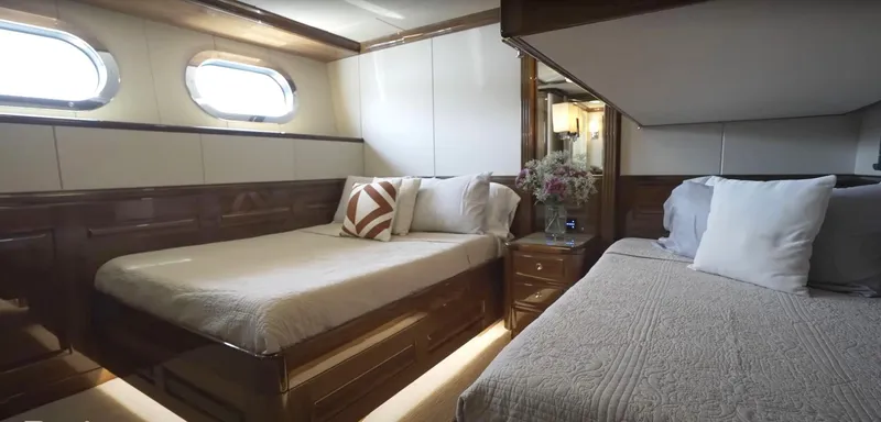 Slide: The Image of Luxurious bedroom in Christensen Model Year 2020 yacht with twin beds and elegant decor. - 22