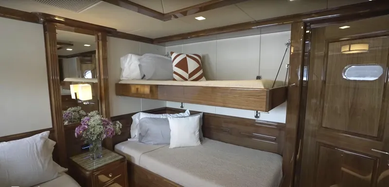 Slide: The Image of Luxurious 2020 Christensen yacht cabin with bunk beds and elegant wooden interior. - 23