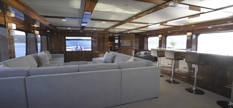 Slide: The Image of Luxurious interior of Christensen Model Year 2020 yacht with spacious seating and bar area. - 25