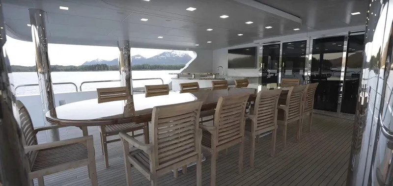 Slide: The Image of Christensen Model Year 2020 yacht with spacious outdoor dining area and scenic views. - 26