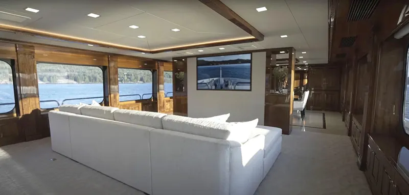 Slide: The Image of Luxurious interior of Christensen Model Year 2020 yacht with large windows and white sofa. - 4