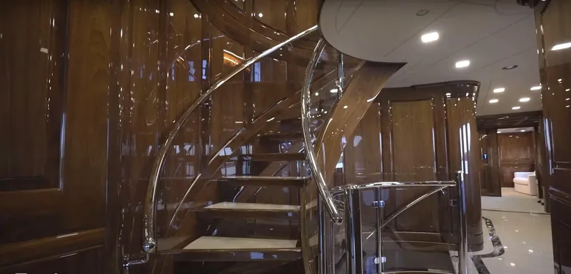 Slide: The Image of Luxurious interior of Christensen Model Year 2020 yacht with elegant spiral staircase. - 6
