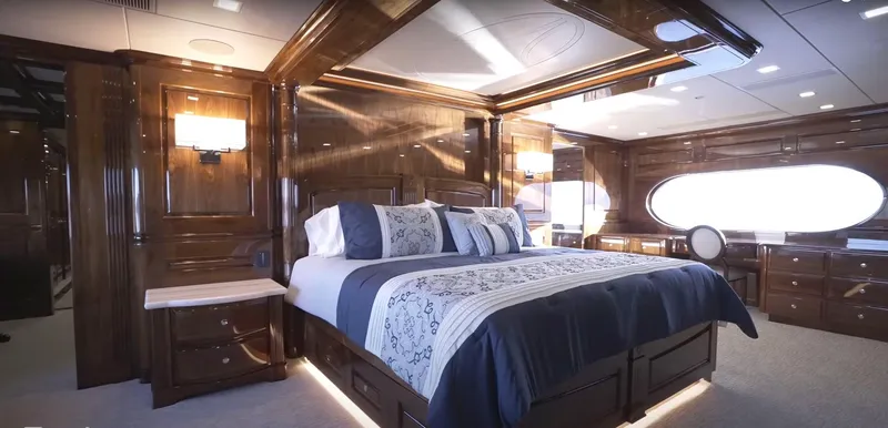 Slide: The Image of Luxurious Christensen 2020 yacht bedroom with elegant wood paneling and modern lighting. - 8