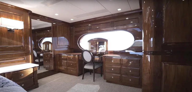 Slide: The Image of Luxurious wooden interior of Christensen Model Year 2020 yacht, featuring elegant cabinetry and a vanity desk. - 9