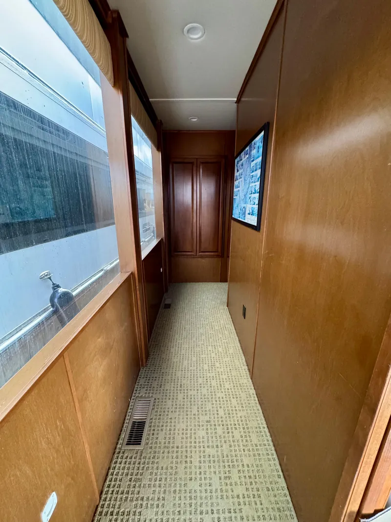 Slide: The Image of Narrow hallway in 2011 Bravada Dreamweaver Trip #16 houseboat with wood paneling and carpet. - 13
