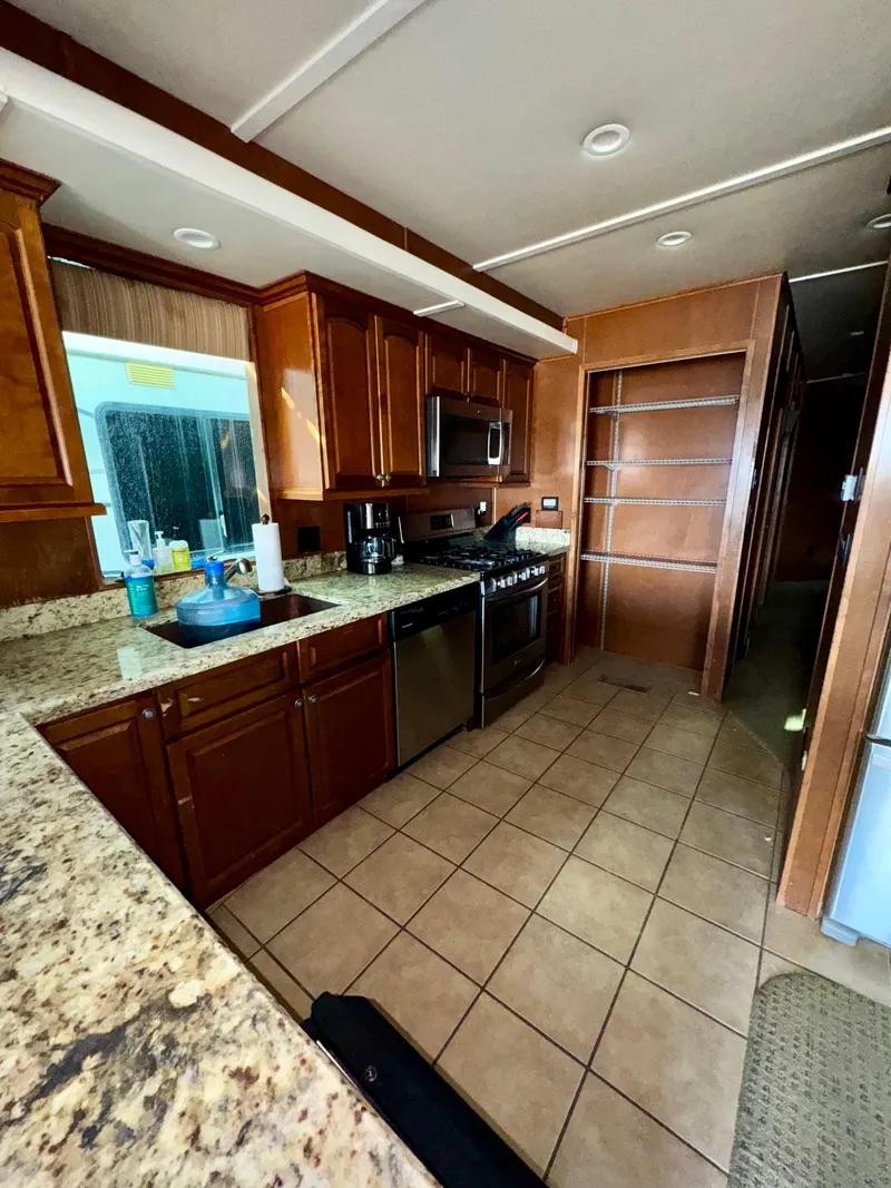 Slide: The Image of Modern kitchen in 2011 Bravada Dreamweaver Trip #16 with granite countertops and wooden cabinets. - 6