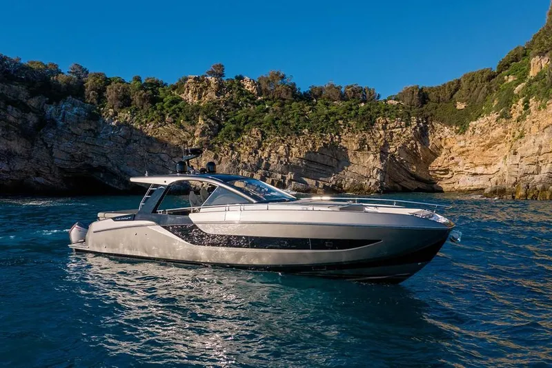 Slide: The Image of 2023 Azimut Verve 47 luxury yacht cruising near rocky coastline. - 1