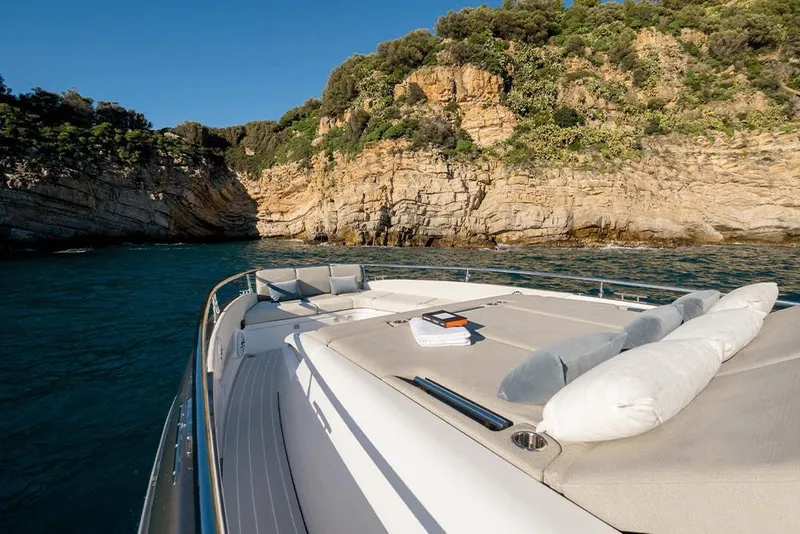 Slide: The Image of Azimut Verve 47 yacht 2023 cruising near rocky coastline with luxurious sunbathing area. - 8