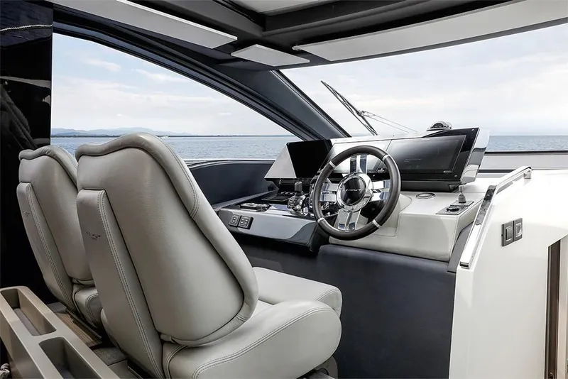 Slide: The Image of 2023 Azimut S8 yacht cockpit with modern steering wheel and dual seats. - 11