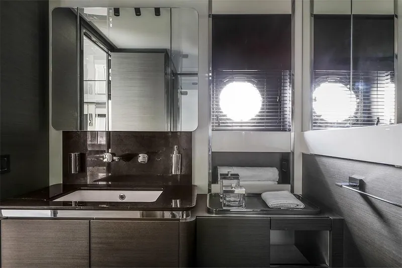 Slide: The Image of Modern bathroom interior of 2023 Azimut S8 yacht with sleek fixtures and porthole windows. - 20
