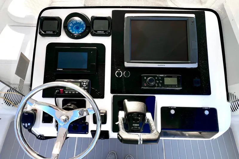 Slide: The Image of 2002 Intrepid 366 boat dashboard with Garmin and Yamaha controls, steering wheel, and navigation instruments. - 10