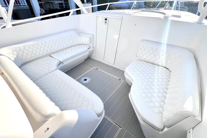 Slide: The Image of Luxurious white seating area on a 2002 Intrepid 366 boat, featuring quilted upholstery. - 16