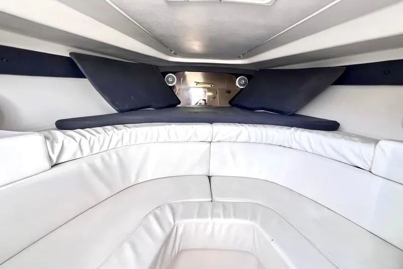 Slide: The Image of Interior cabin of a 2002 Intrepid 366 boat with white seating and cushions. - 18