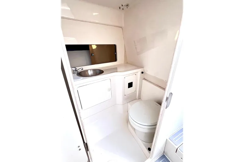 Slide: The Image of 2002 Intrepid 366 boat bathroom with sink, toilet, and storage cabinet. - 19