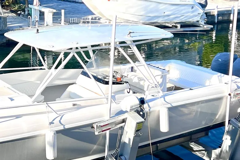 Slide: The Image of 2002 Intrepid 366 boat docked, featuring sleek design and spacious seating area. - 2