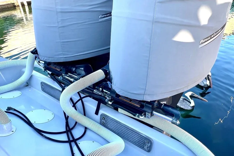 Slide: The Image of Covered outboard motors on a 2002 Intrepid 366 boat, docked in calm water. - 20