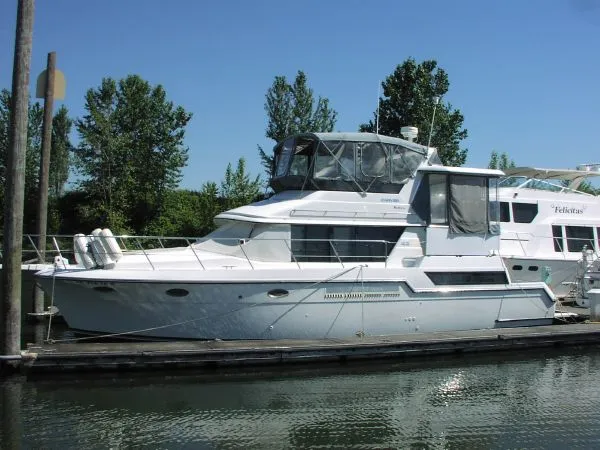 The Image of 1991 Carver 430 Cockpit Motor Yacht docked on a sunny day. - 0