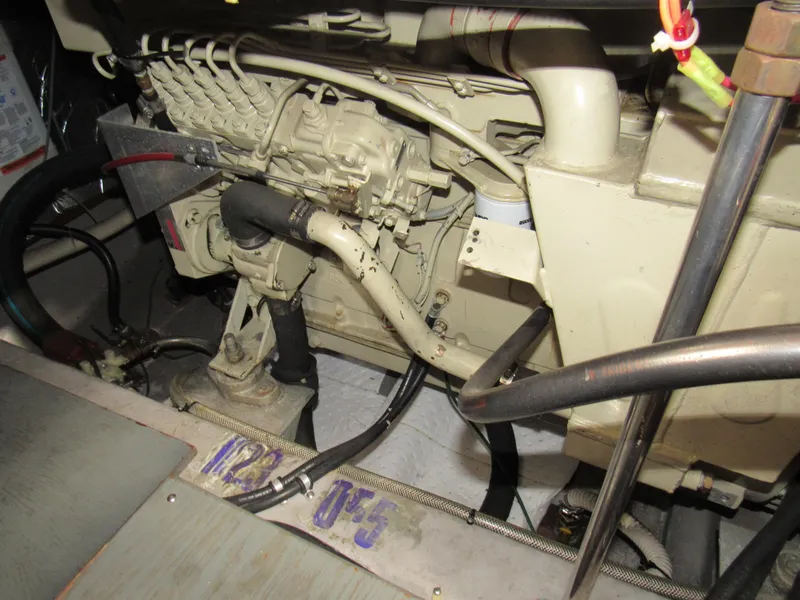 Slide: The Image of Engine compartment of a 1991 Carver 430 Cockpit Motor Yacht, showcasing mechanical components. - 18