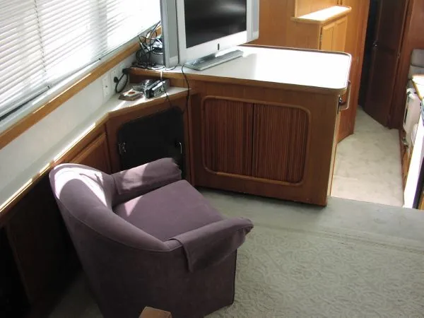 Slide: The Image of Interior of 1991 Carver 430 Cockpit Motor Yacht with chair and TV setup. - 5