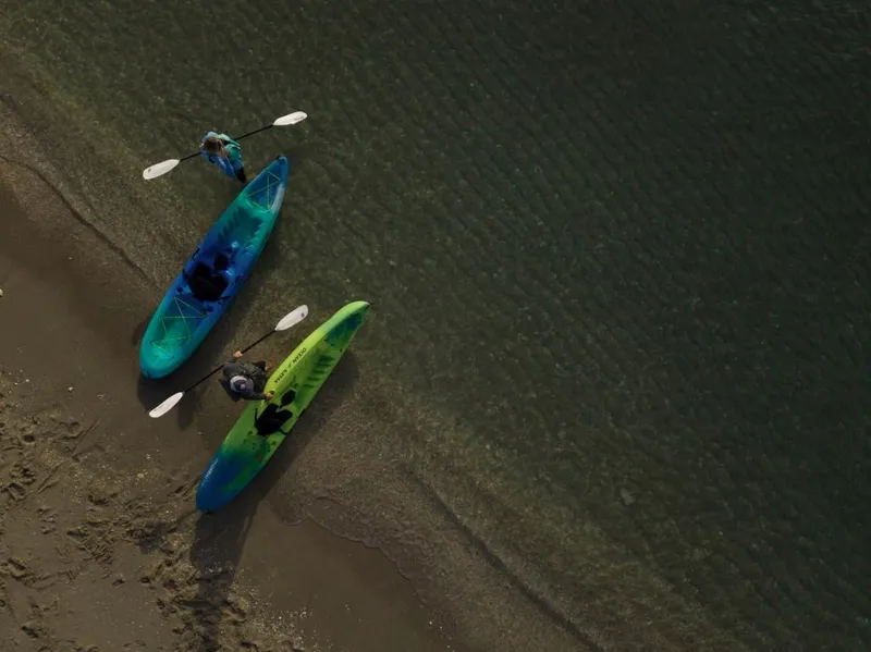 Slide: The Image of Aerial view of two Ocean Kayak Malibu 11.5 kayaks on a sandy beach, 2023 model. - 14