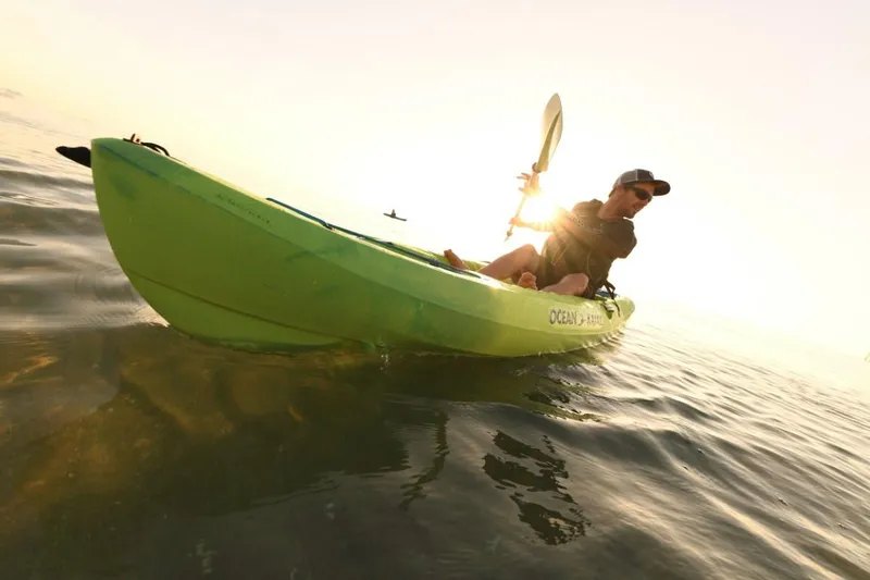Slide: The Image of Person kayaking on Ocean Kayak Malibu 11.5, 2023 model, at sunset. - 9