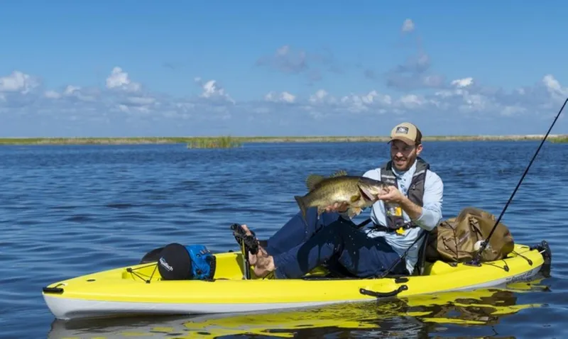 Slide: The Image of Man fishing on a 2023 Hobie Passport 10.5 kayak, holding a large fish. - 4