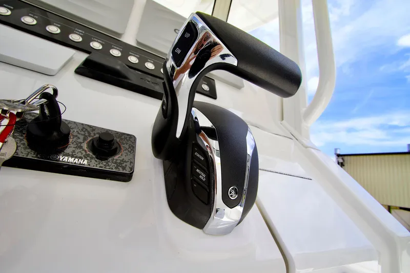 Slide: The Image of Control panel of 2026 Regulator 24XO boat featuring Yamaha throttle and keys. - 2