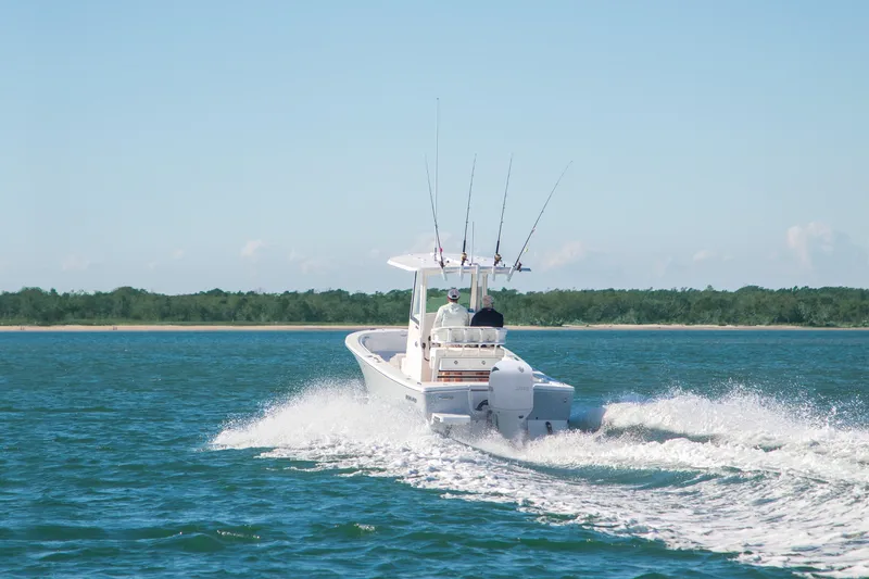 Slide: The Image of 2026 Regulator 24XO boat cruising on open water with fishing rods. - 3