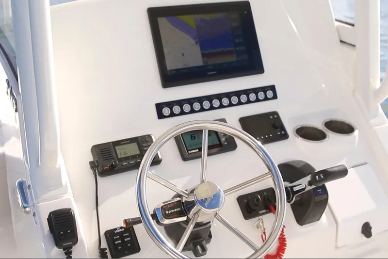 Slide: The Image of Helm of 2026 Regulator 24XO boat with modern navigation equipment and controls. - 6