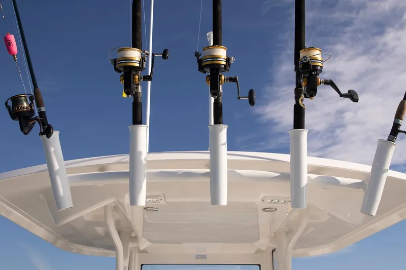 Slide: The Image of Fishing rods on a 2026 Regulator 24XO boat against a clear blue sky. - 8