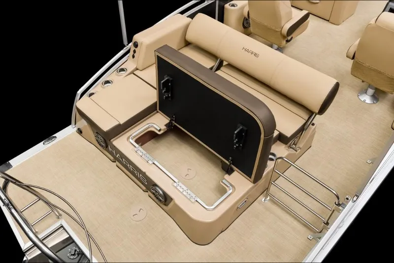 Slide: The Image of 2022 Harris Solstice 230 boat interior with tan seating and storage compartment. - 14