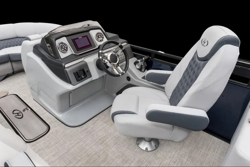Slide: The Image of 2022 Harris Solstice 230 boat helm with modern controls and luxurious captain's chair. - 9